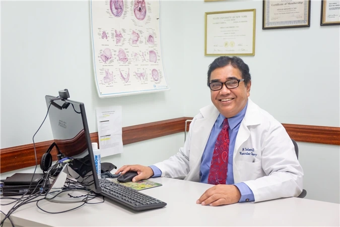Dr. Islam at his desk in the Renew Vein Centers office
