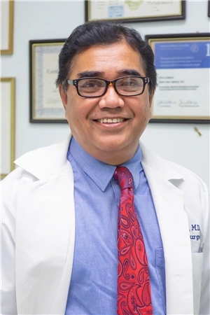 Dr. Islam, vascular surgeon at Renew Vein Centers, smiling in a white coat